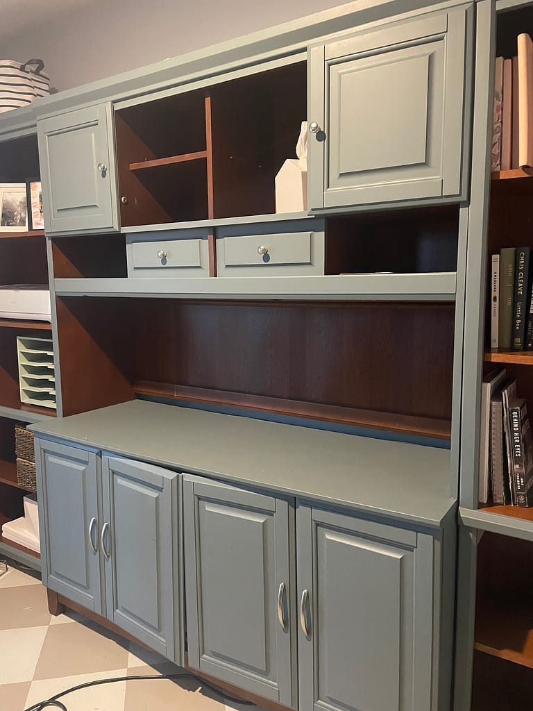 Cherry-toned wood office cabinetry painted blue