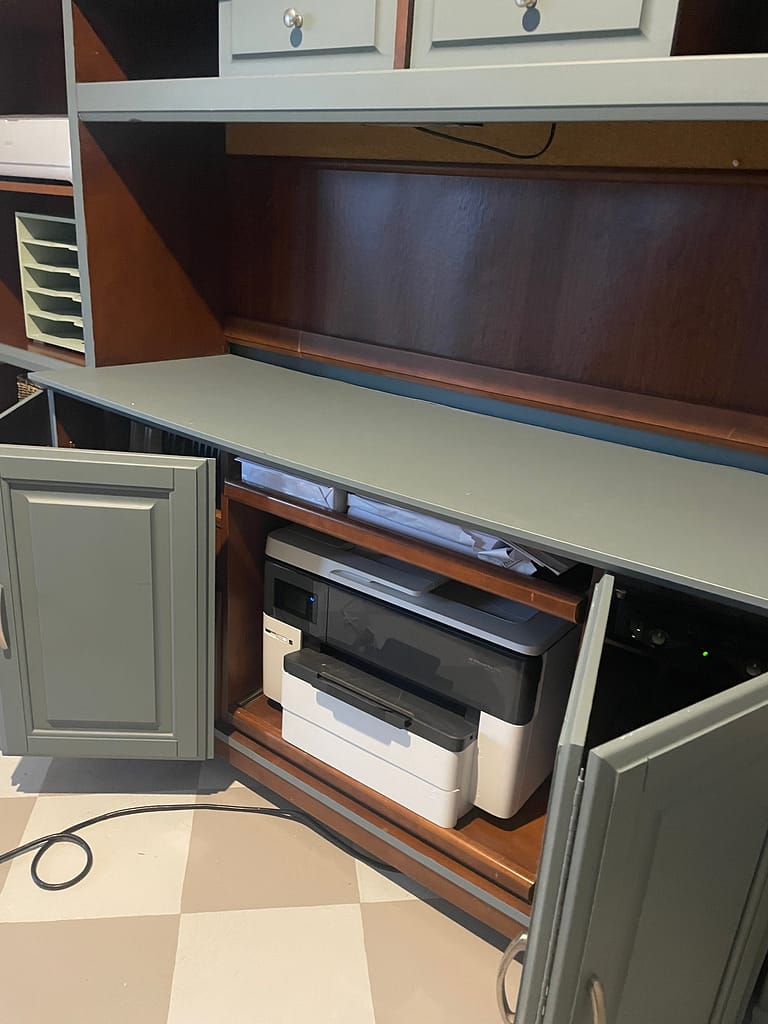 Office cabinetry opened to reveal hidden printer
